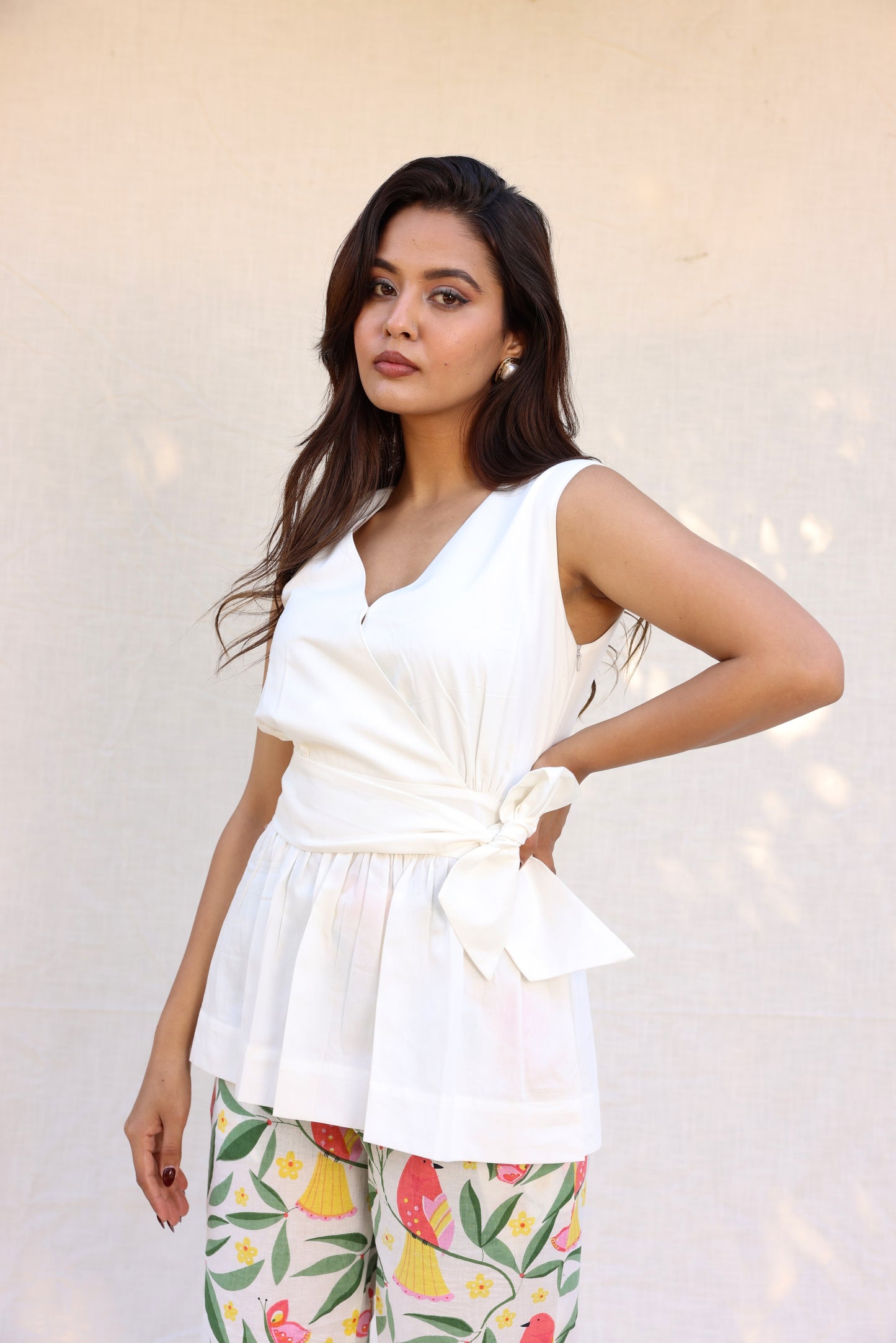 Sleeveless peplum top with tie knot belt with printed pants set